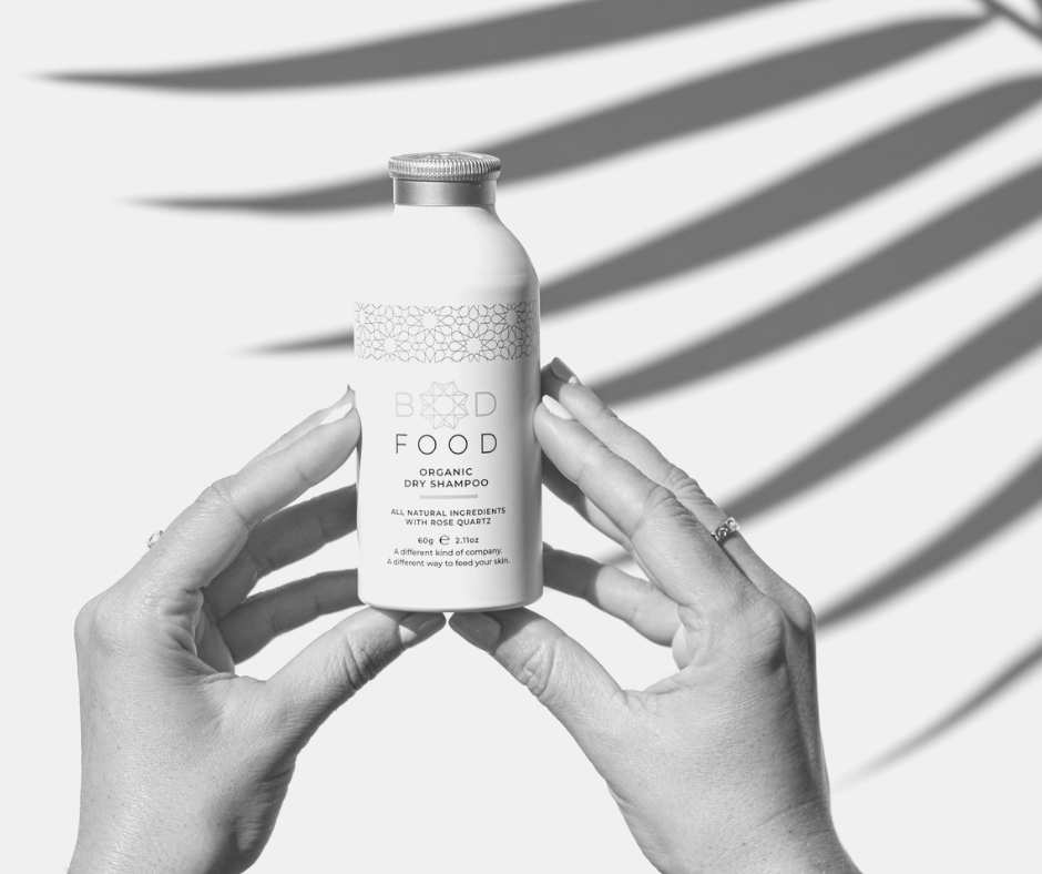 Natural Organic Dry Shampoo Australia. Hands holding a bottle of BodFood Natural Organic Dry Shampoo.